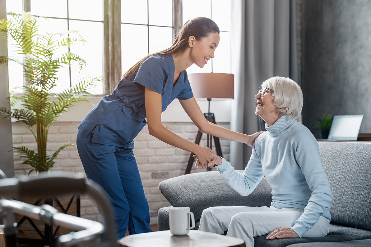 nurse greeting an elderly woman at her home